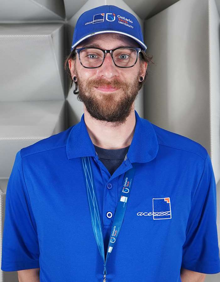 ACE Ontario Tech Research and Development Engineer, Eric Whalls, in branded blue polo